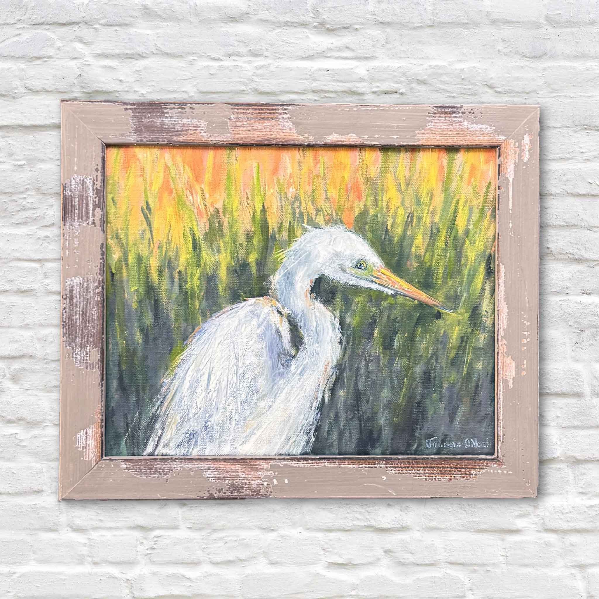 “Elegance: A Study” original 10x8 oil painting by local Lowcountry artist Jeanne O’Neal featuring a white egret in marsh grass, professionally framed and photographed against white brick at Gray Man Gallery in Pawleys Island, South Carolina