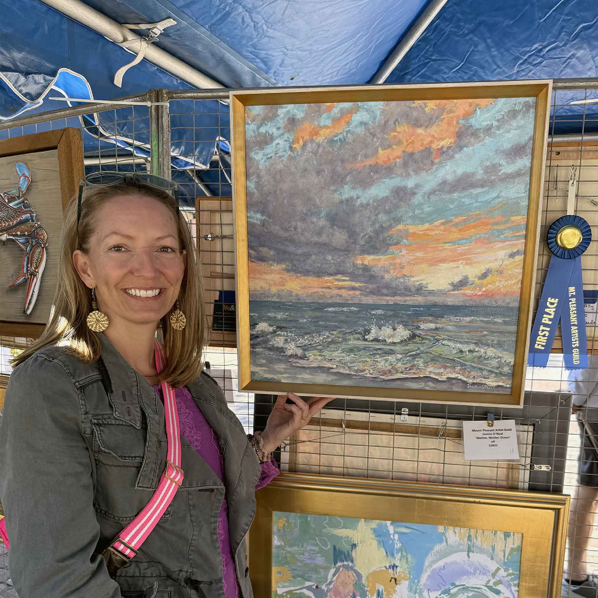 Jeanne O’Neal holding her original oil painting Mother, Mother Ocean at the 2025 Mount Pleasant ArtFest, First Place award-winning coastal ocean painting inspired by the South Carolina coast.