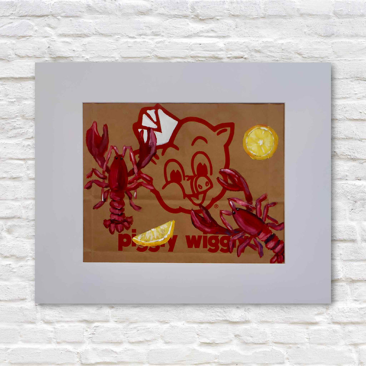 Lobstahs & Lemons, original acrylic painting by local artist Jenny Reynolds featuring two bright red lobsters, a yellow lemon slice, and a lemon wedge surrounding the iconic red Piggly Wiggly pig mascot on a genuine brown paper grocery bag. Presented in a wide light gray mat against a white brick background at Gray Man Gallery in Pawleys Island, South Carolina.