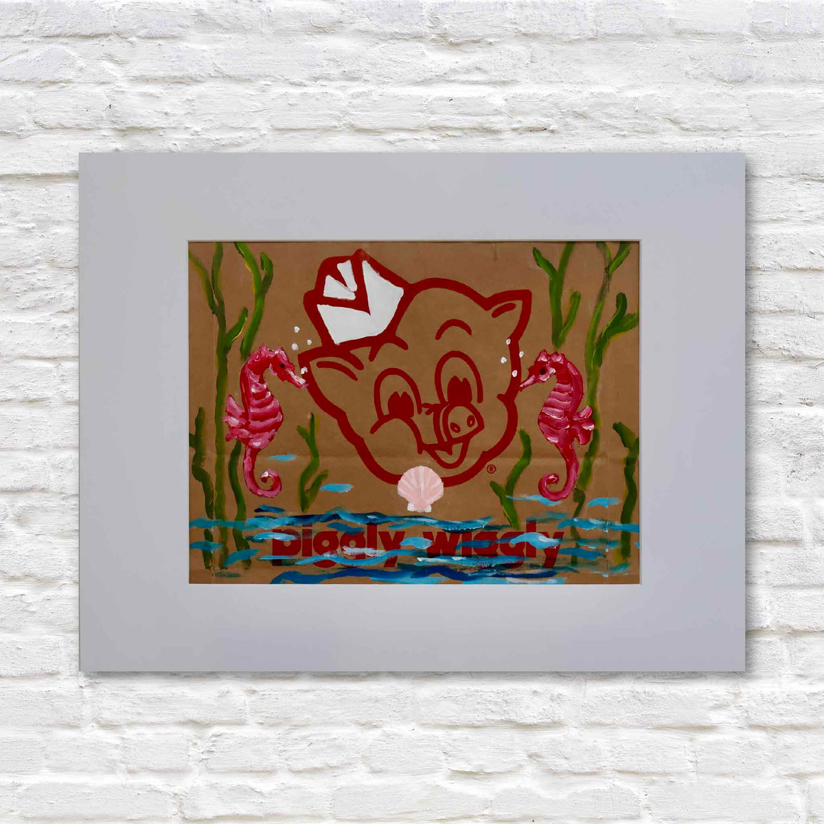 Seahorsin’ Around, original acrylic painting by local artist Jenny Reynolds featuring two bright pink seahorses, green seaweed, blue ocean water, and a pink seashell surrounding the iconic red Piggly Wiggly mascot on a genuine brown paper grocery bag. Displayed in a wide light gray mat at Gray Man Gallery in Pawleys Island, South Carolina.