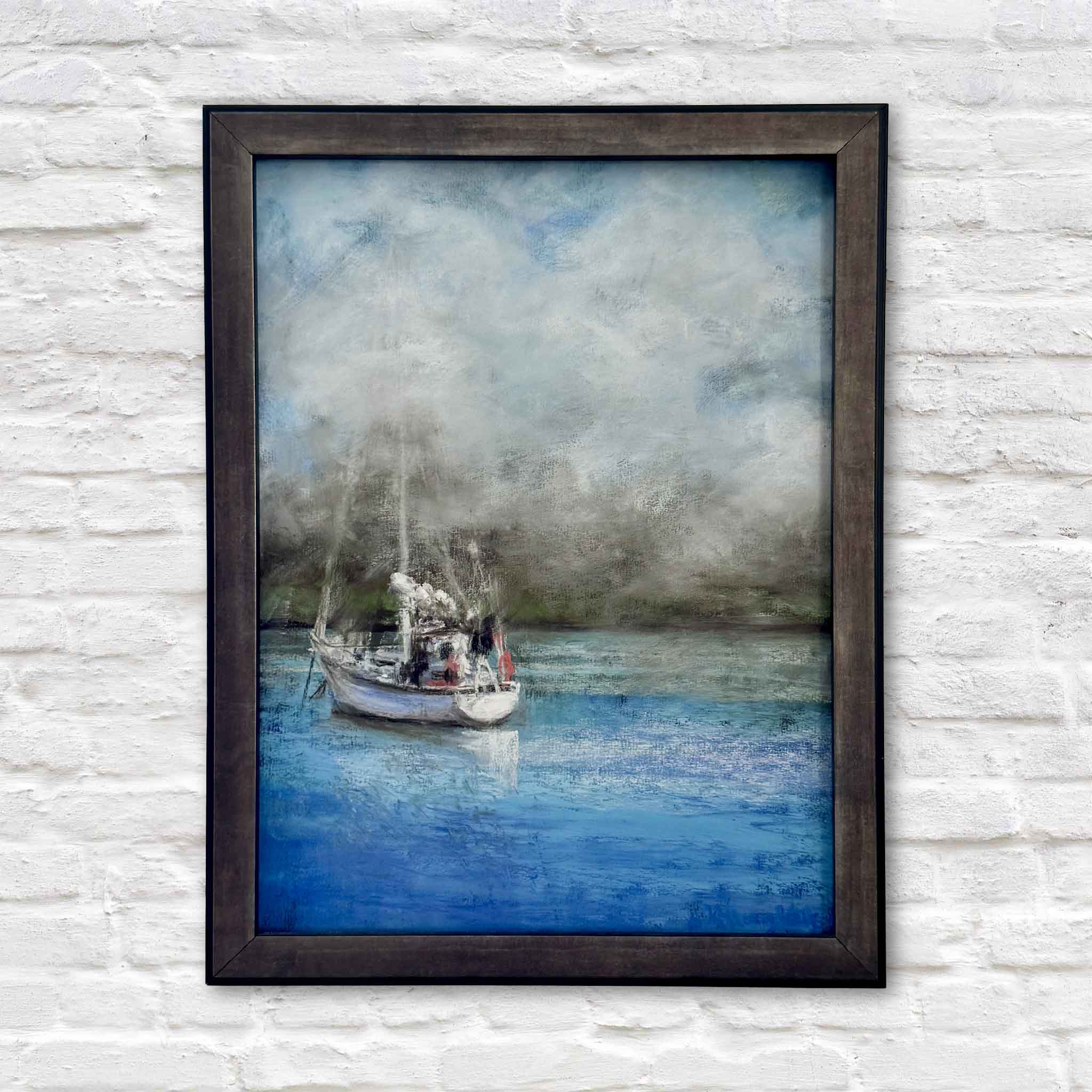 A Foggy Start by Joanne Willoughby, an original pastel featuring a sailboat resting on calm blue water beneath a soft foggy morning sky, professionally framed with Water White glass and available at Gray Man Gallery in Pawleys Island, South Carolina.