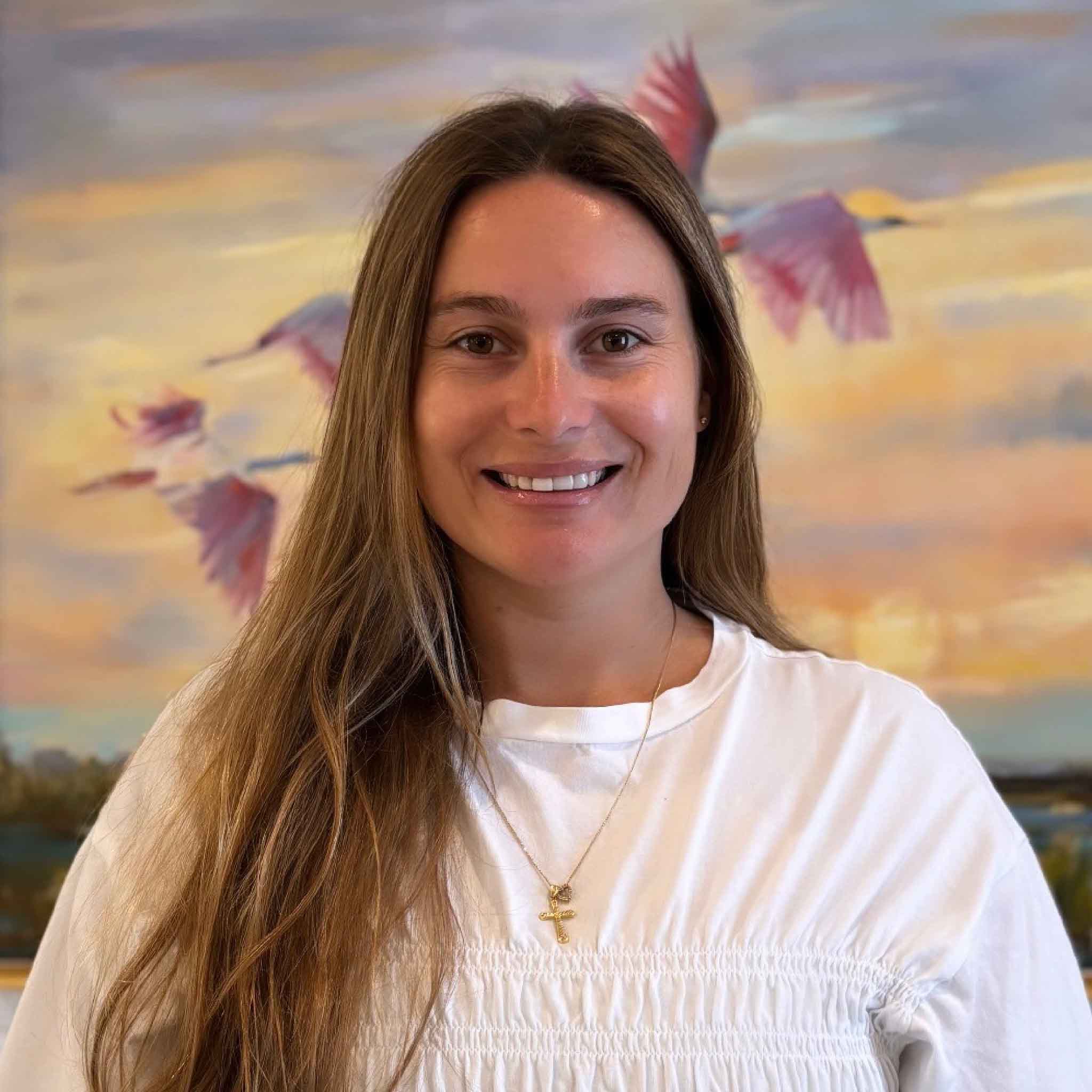 Portrait of Kyra Moree, social media and marketing coordinator at Gray Man Gallery in Pawleys Island, South Carolina. Kyra works with local artists, promotes original artwork and custom framing services, and helps share the creative spirit of the Lowcountry through the gallery's website, events, and social media.