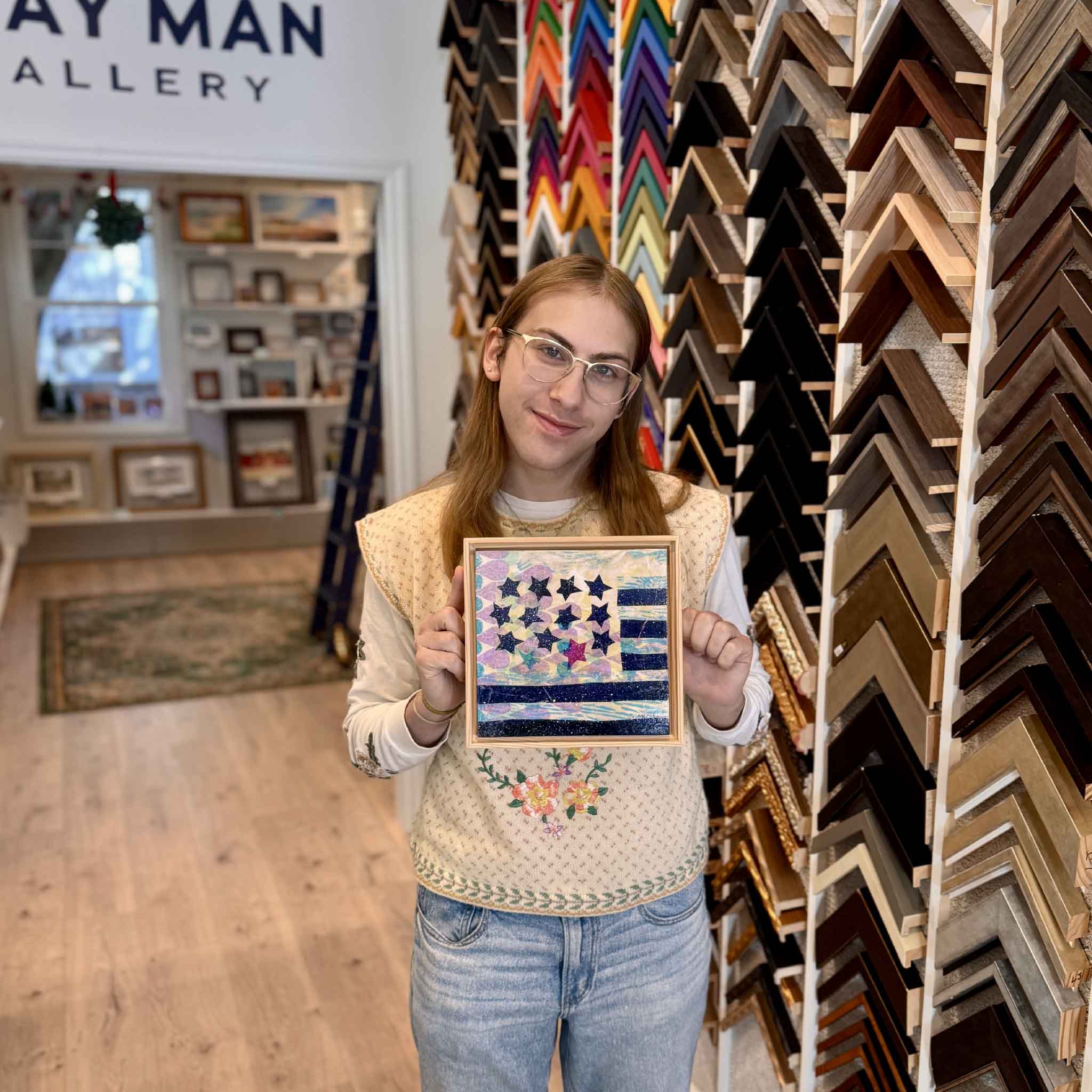 Team member holding Laurie McIntosh Residuals 1A to show size and scale of the 8x8 framed artwork.