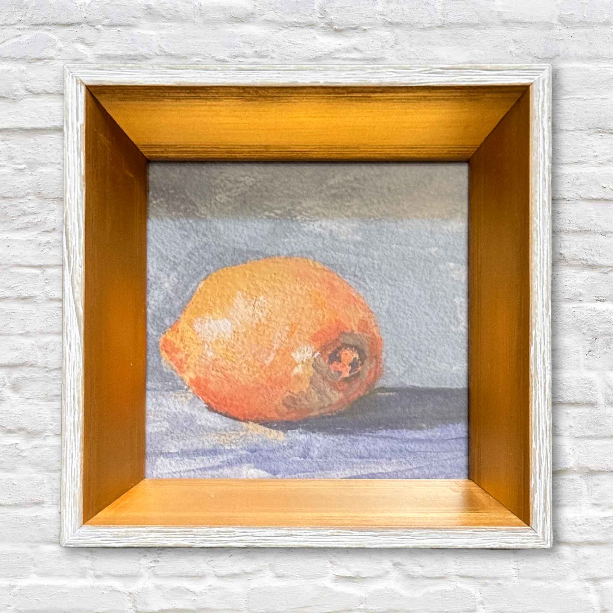 Primary product image of “Lemon Drop” by Jeanne O’Neal, a 4x4 inch framed lemon art print in a classic gold frame. Photographed at Gray Man Gallery in Pawleys Island, South Carolina, this Lowcountry local artist piece features warm citrus tones and soft painterly texture.