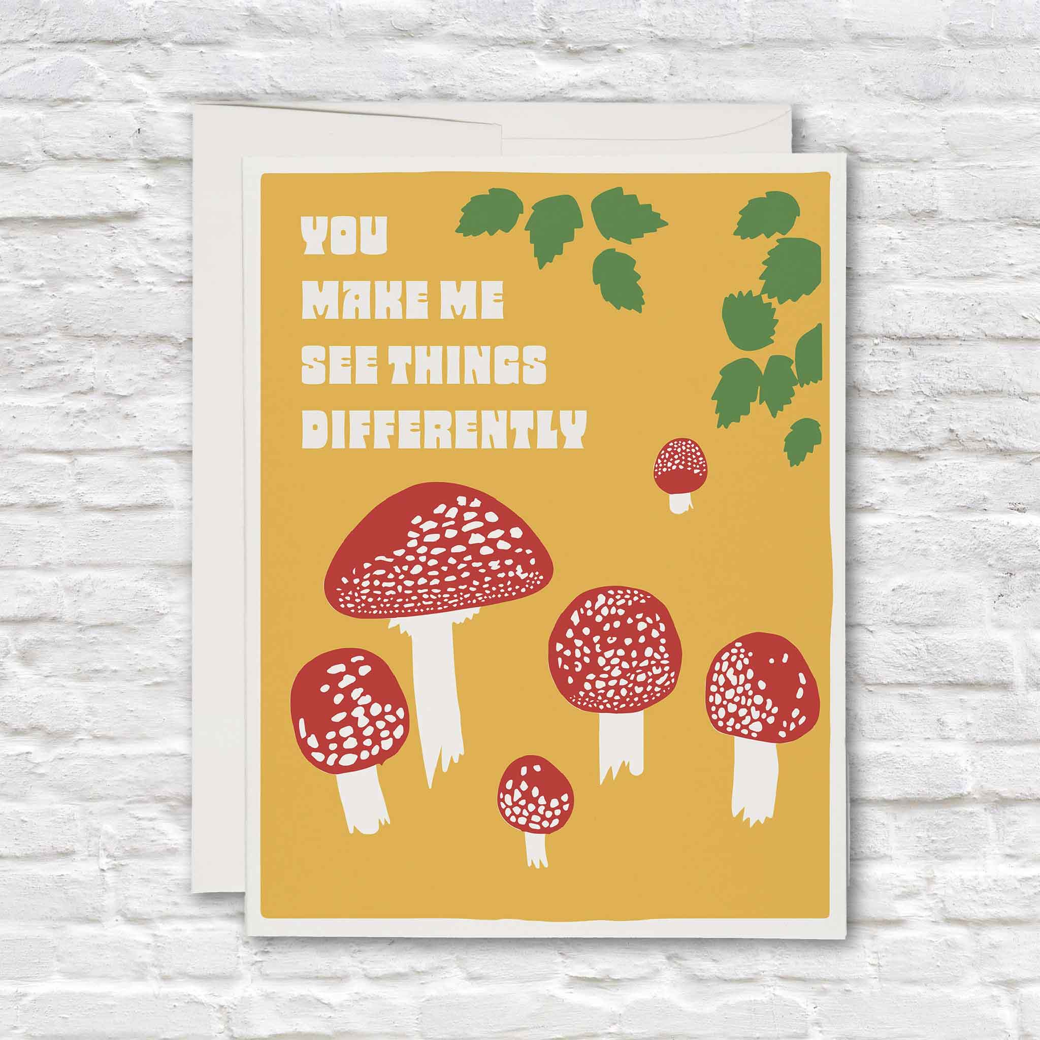 You Make Me See Things Differently mushroom love card by Lonely Palm Ranch for Red Cap Cards, featuring retro red and white mushrooms on a golden yellow background, available inside Gray Man Gallery in Pawleys Island, South Carolina.