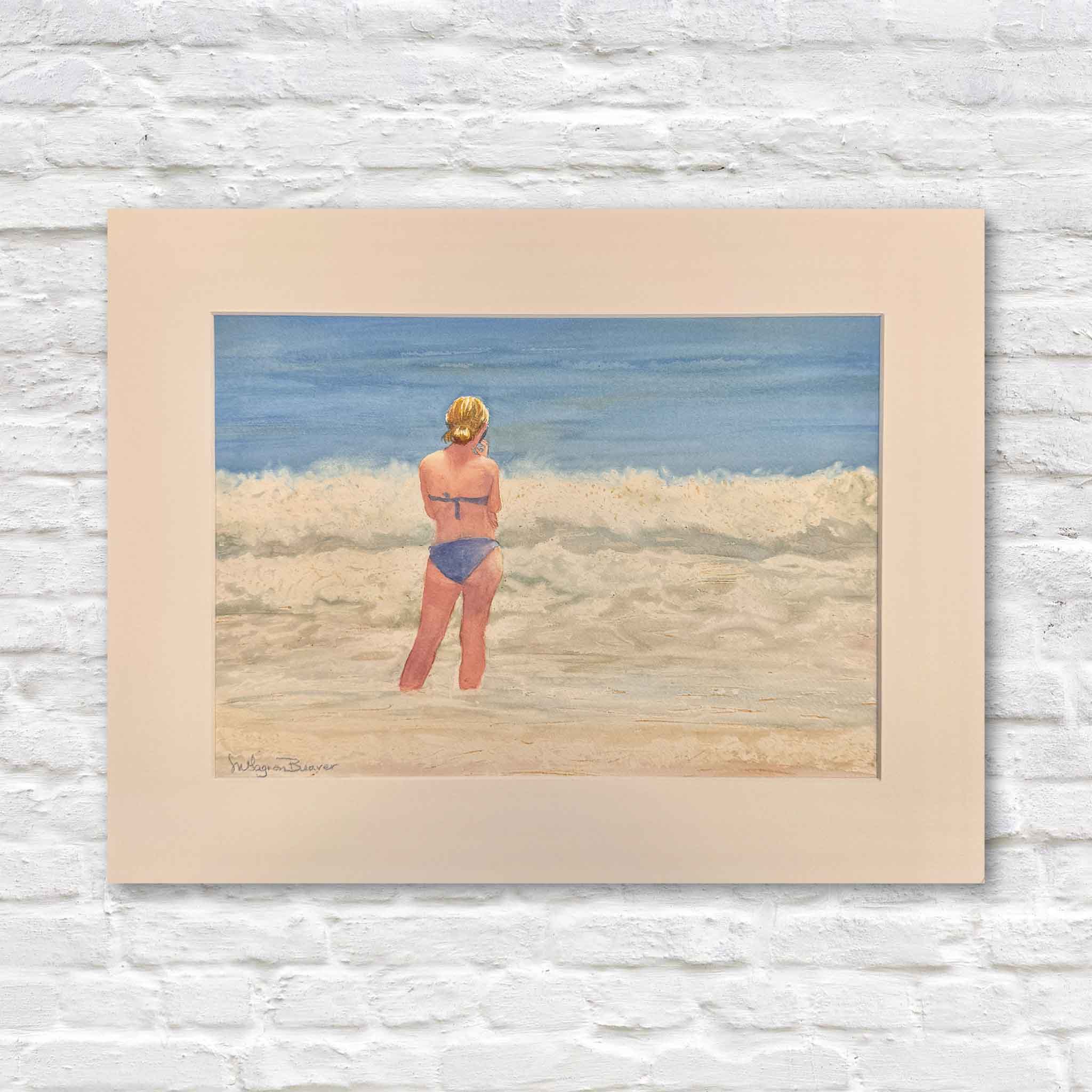 Original watercolor by Mimi Beaver of a woman standing at the shoreline with a phone in hand, part of the Giving Collection supporting senior dog rescue.