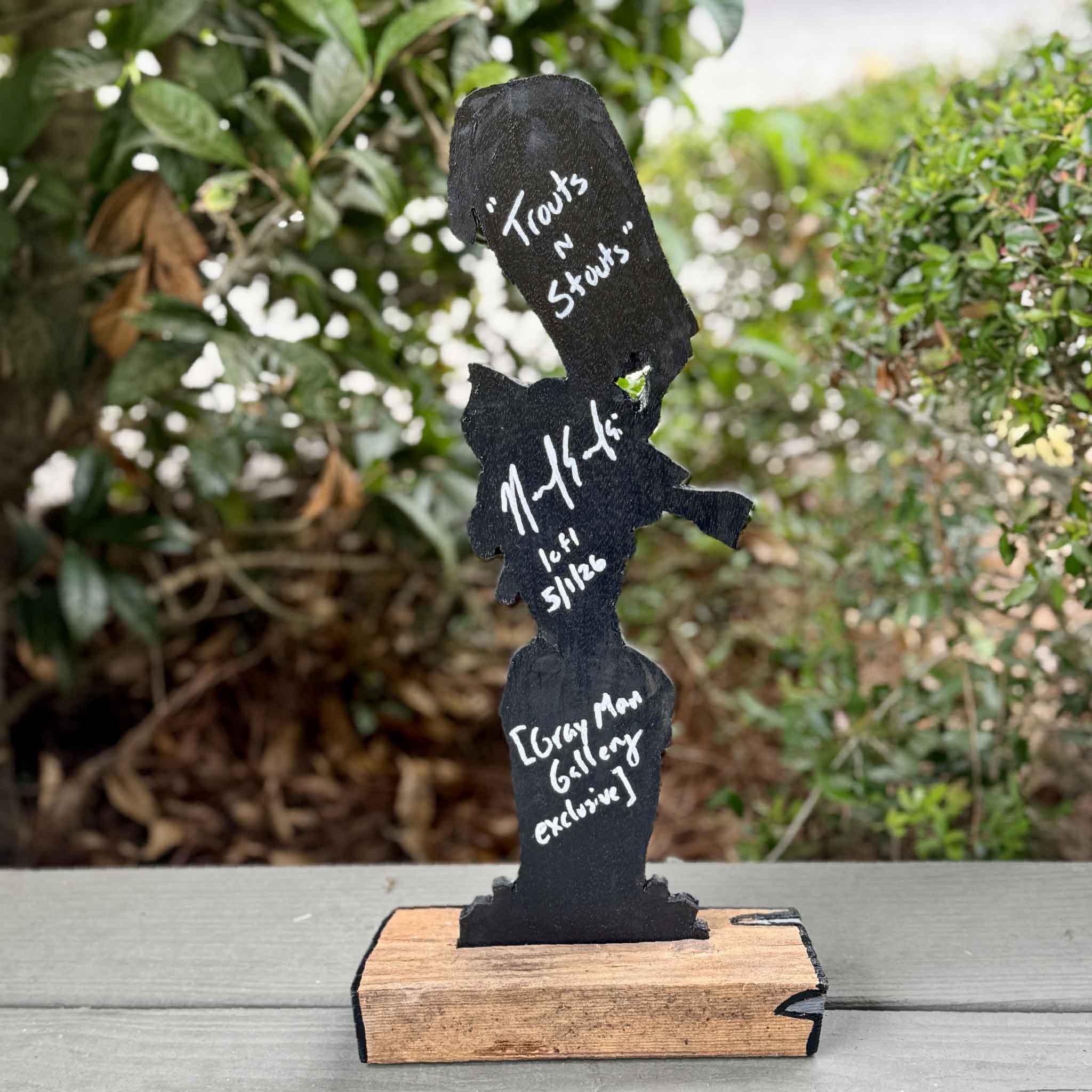 Trouts 'n Stouts by Charleston artist Nick Kawczynski, a one-of-a-kind mixed media sculpture featuring hand-painted sea trout leaping through foam-topped stout beers. Created from reclaimed marine-grade plywood salvaged through the Lowcountry Maritime Society boatbuilding program and mounted on a found wood base. Available at Gray Man Gallery in Pawleys Island, South Carolina.