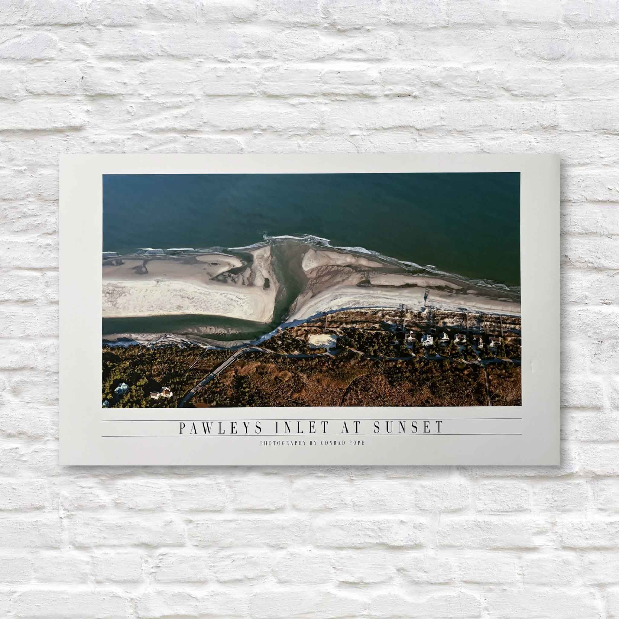 Pawleys Inlet at Sunset by Conrad Pope, an aerial coastal photograph showing winding tidal channels, sandbars, and deep blue water at sunset, available at Gray Man Gallery in Pawleys Island, South Carolina.