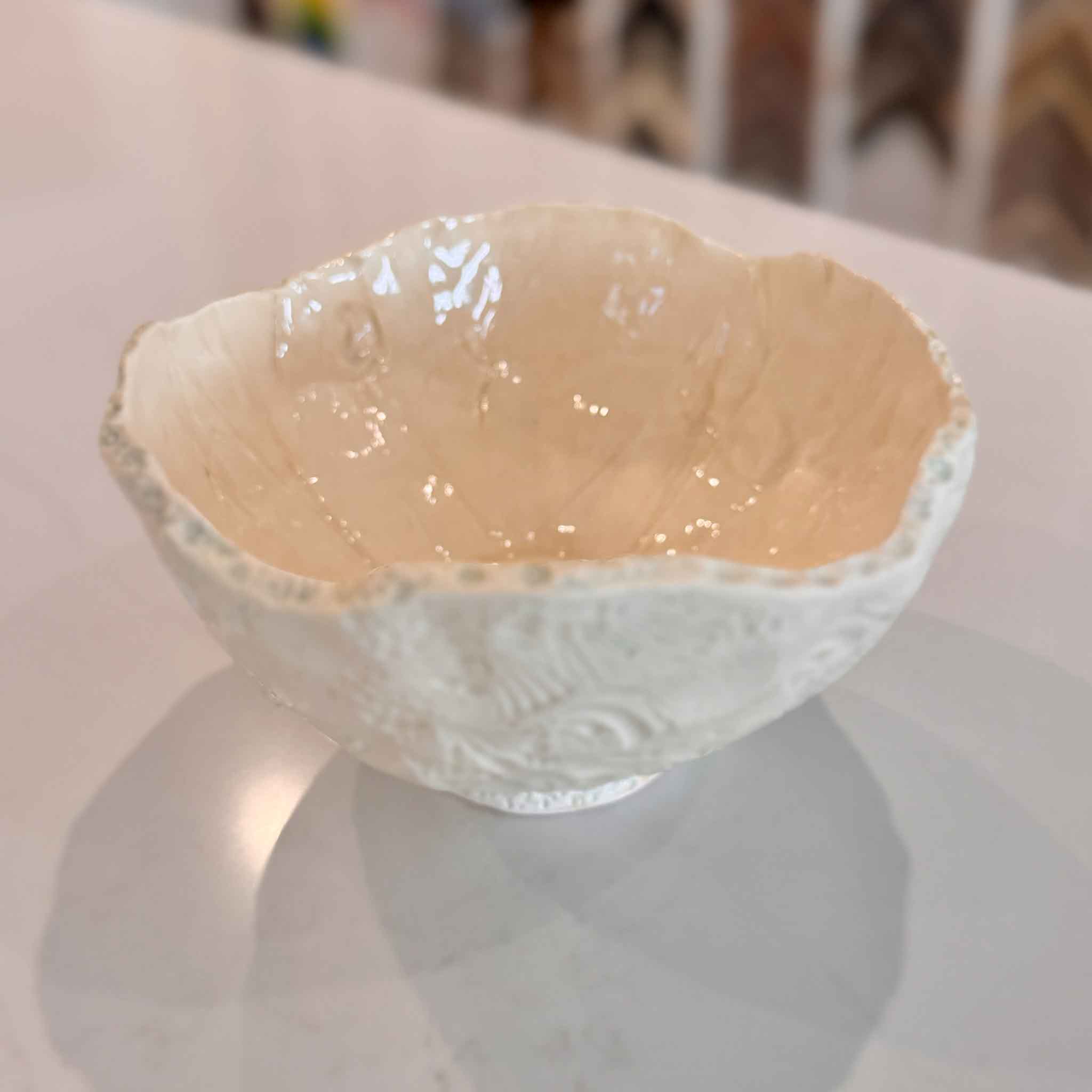 Close-up of Pawleys Shore Shell Bowl by Vida Miller showing clear glazed interior, hand-pressed shell textures, and flowing coastal-inspired ceramic finish