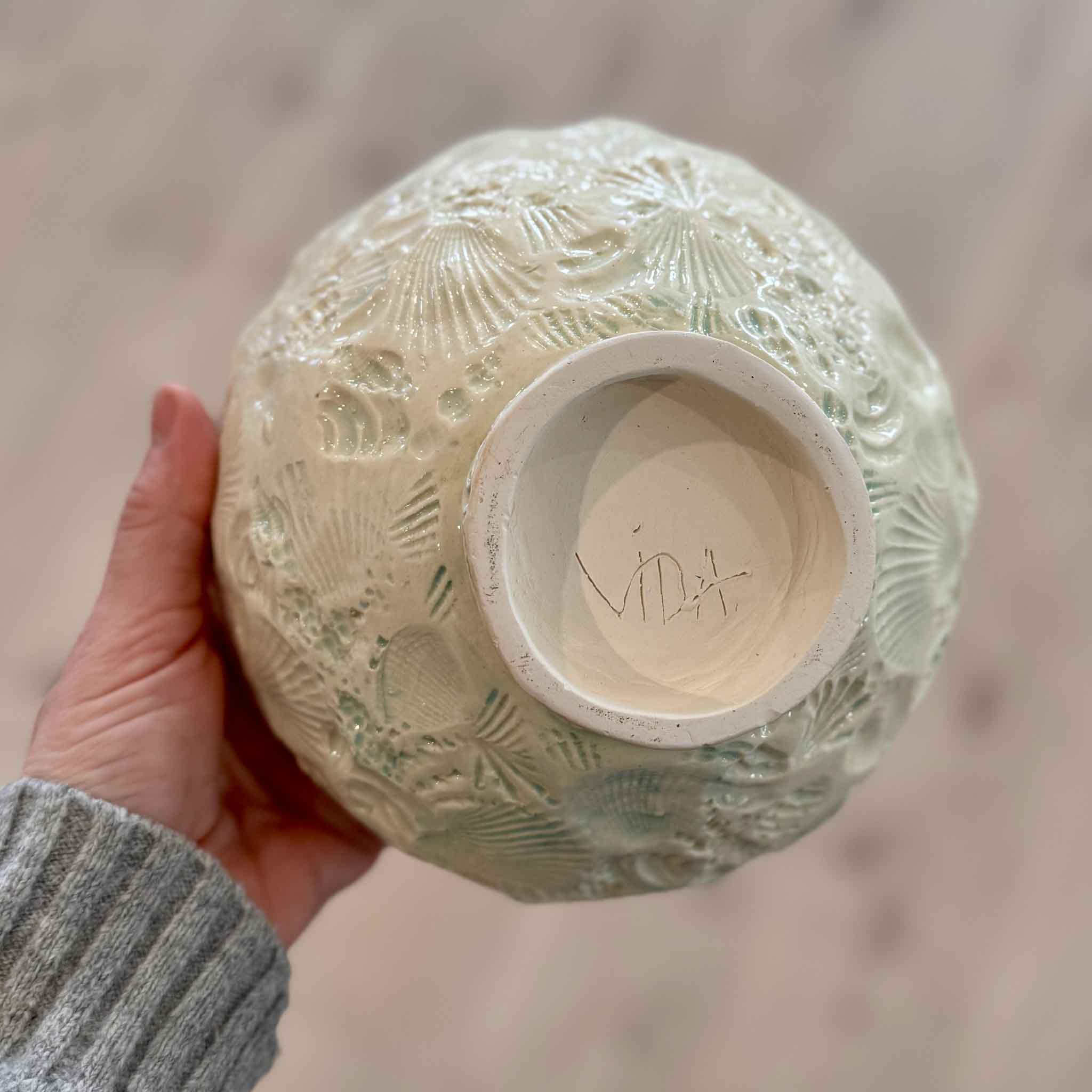 Bottom view of Pawleys Shore Shell Bowl signed by Vida Miller, showing handmade ceramic base and shell-textured exterior at Gray Man Gallery