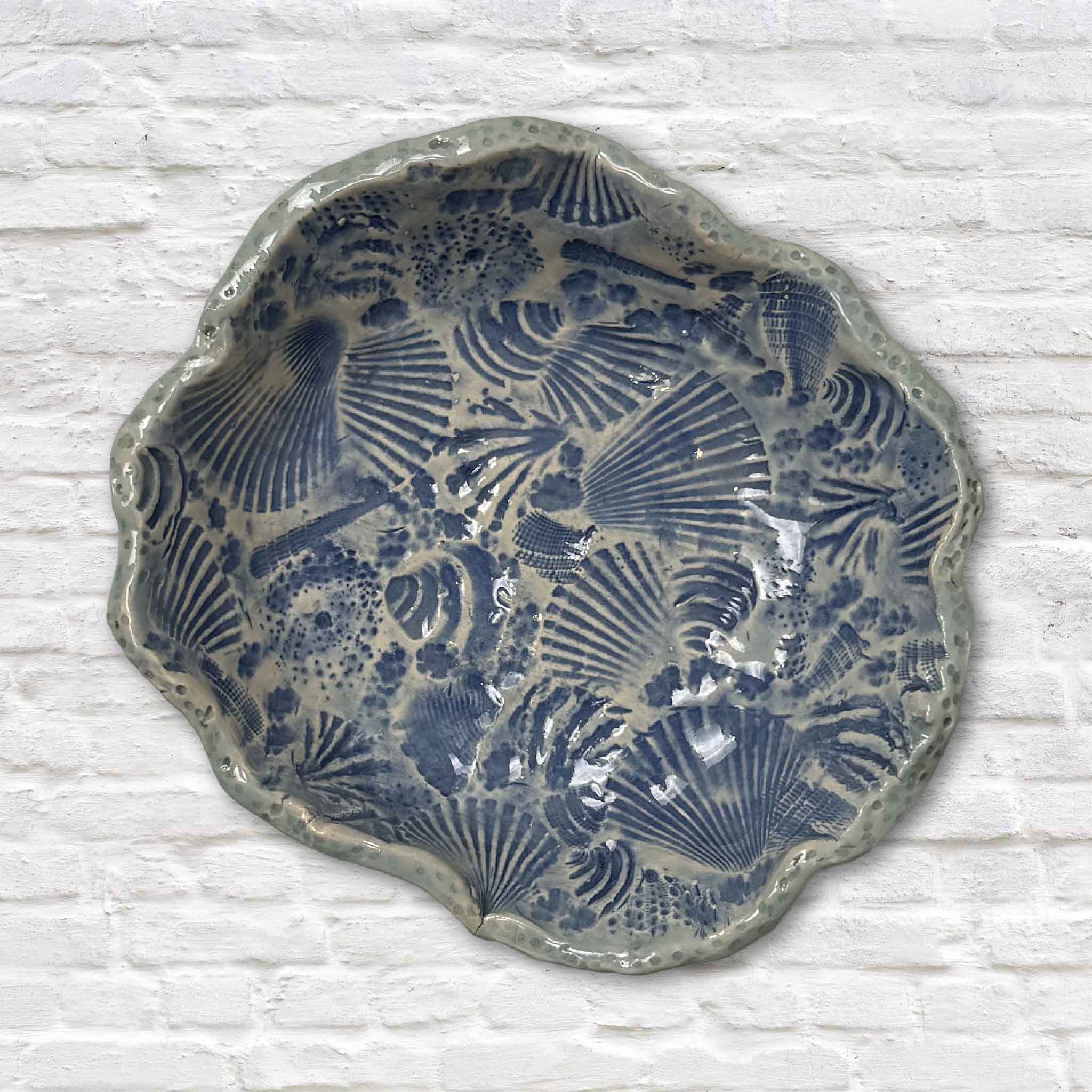 Handmade Pawleys Shore Shell Dish in Sea Glass Blue by local artist Vida Miller featuring hand-pressed shells from Pawleys Island covering the entire ceramic surface at Gray Man Gallery