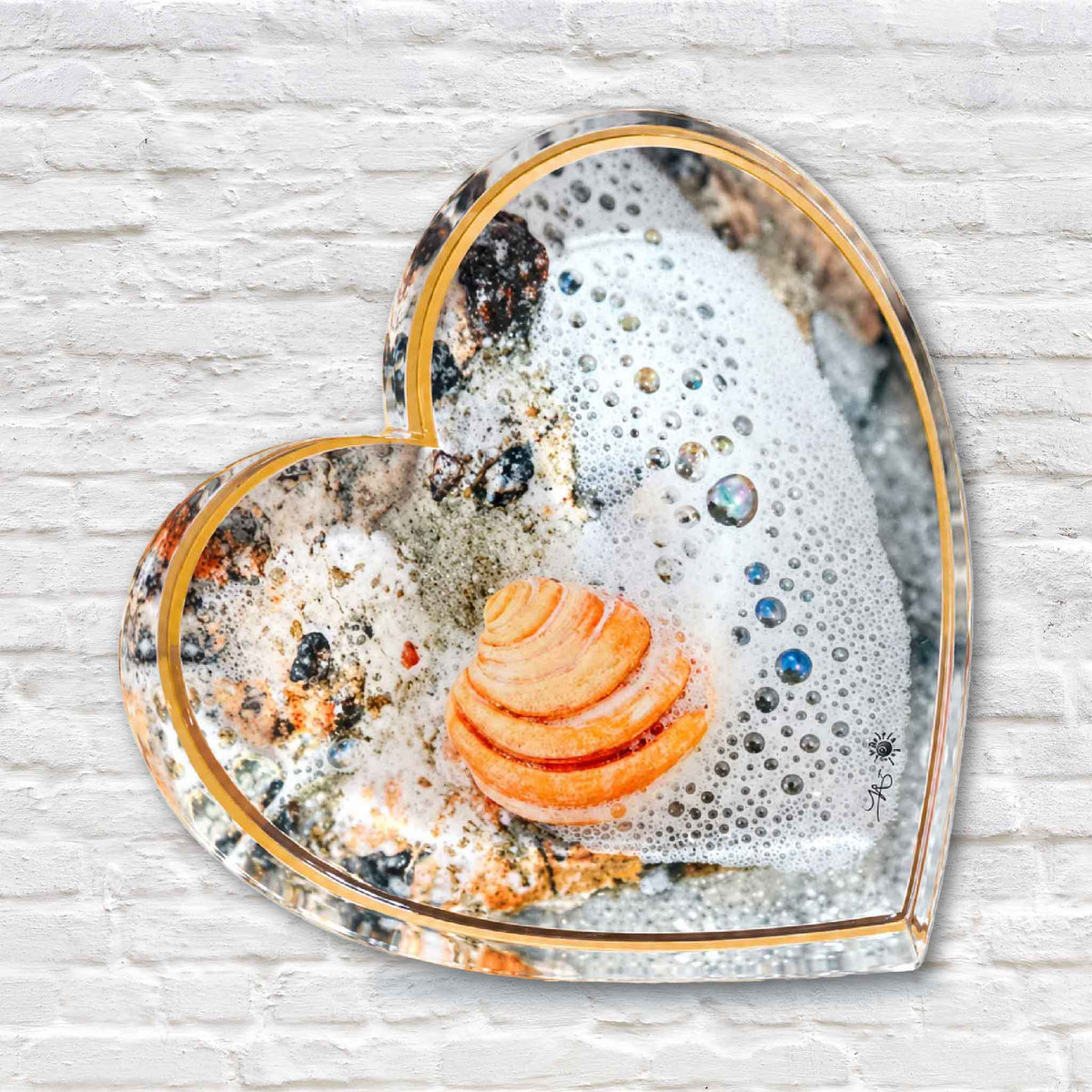Heart-shaped acrylic art block from Tanya Ackerman’s Pieces of Pawleys collection featuring a peach-colored shell, sea foam and coastal details photographed in Pawleys Island, South Carolina, available at Gray Man Gallery.