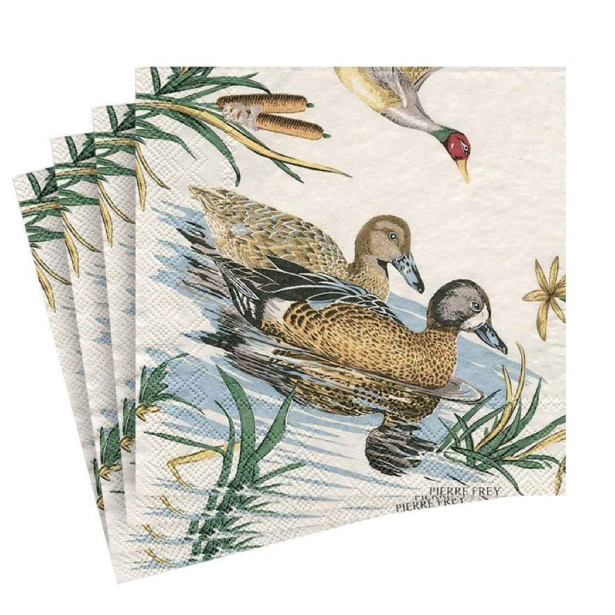 Stack of Pierre Frey Sologne Cocktail Napkins by Caspari showcasing detailed artwork of ducks gliding across marsh water with reeds and a flying mallard overhead. These premium German-made triple-ply paper napkins bring timeless sporting style to cocktail parties, outdoor entertaining, and elegant table settings at Gray Man Gallery in Pawleys Island, South Carolina.