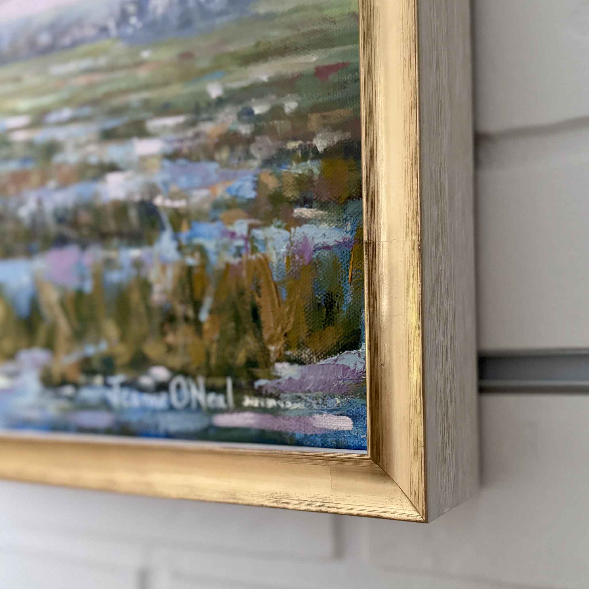 Detail of the gold floater frame and textured brushwork on Jeanne O’Neal’s Pink Playground oil painting.