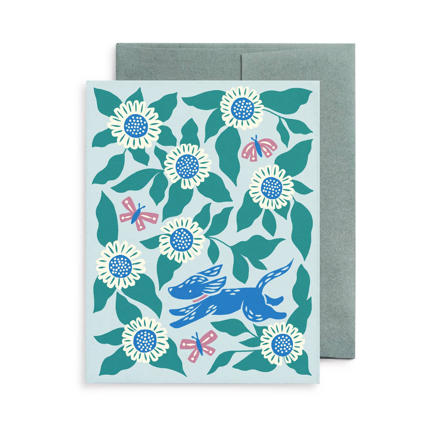 Blank greeting card featuring original artwork by Chrissie Van Hoever of a joyful blue dog running through oversized white daisies, leafy greenery, and butterflies. Printed on premium recycled paper with a kraft envelope and available at Gray Man Gallery in Pawleys Island.
