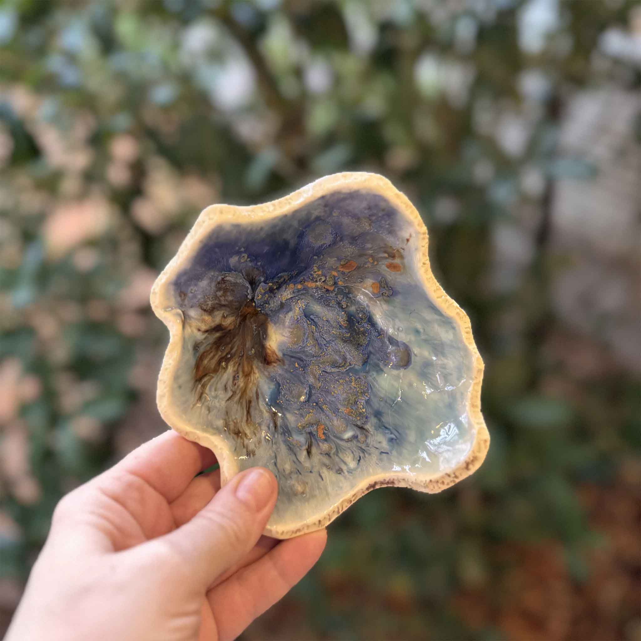 One-of-a-kind Seaspray pottery bowl by Vida Miller with swirling blue and coastal-inspired glaze. Pictured at Gray Man Gallery.
