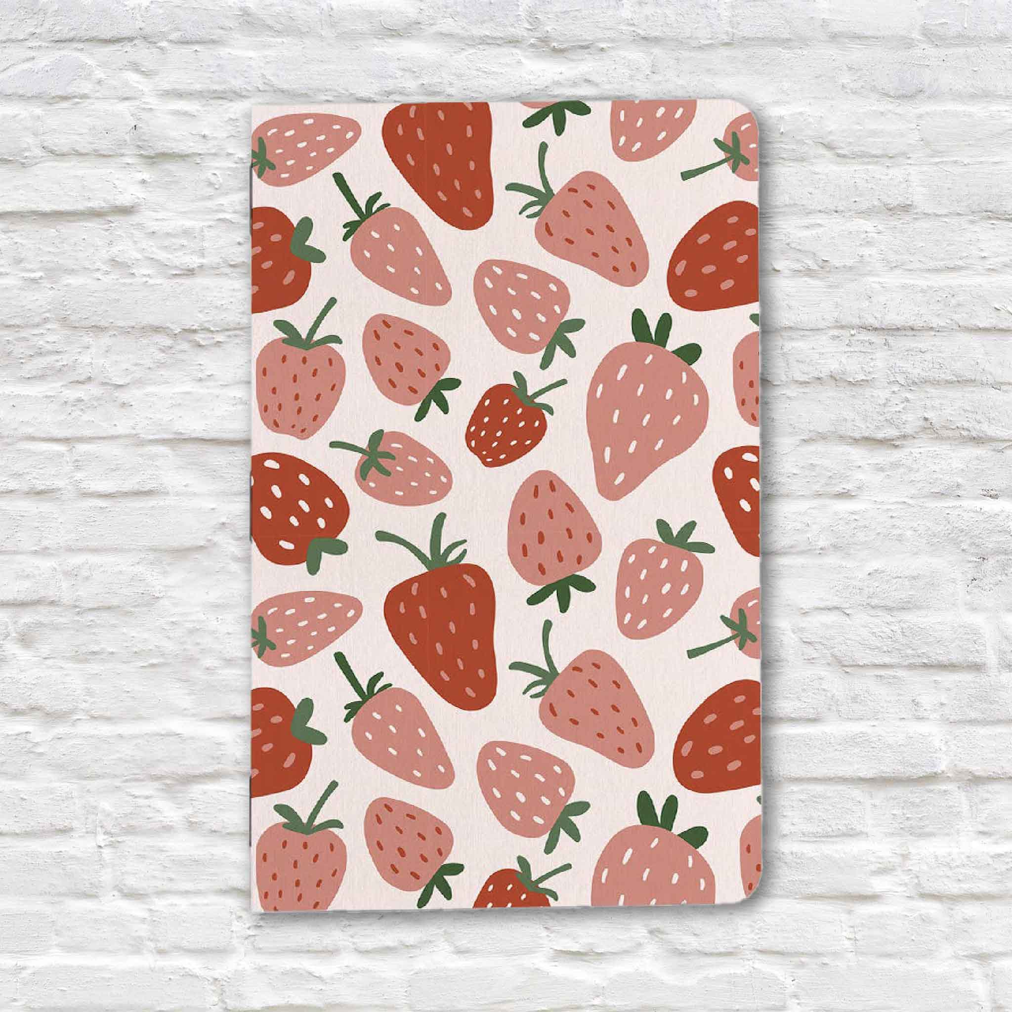 Strawberry Fields 5x7 lined notebook featuring a playful strawberry pattern in shades of pink, coral, and red. This lined journal is designed for everyday note-taking, journaling, lists, and creative writing and is available at Gray Man Gallery in Pawleys Island, South Carolina.