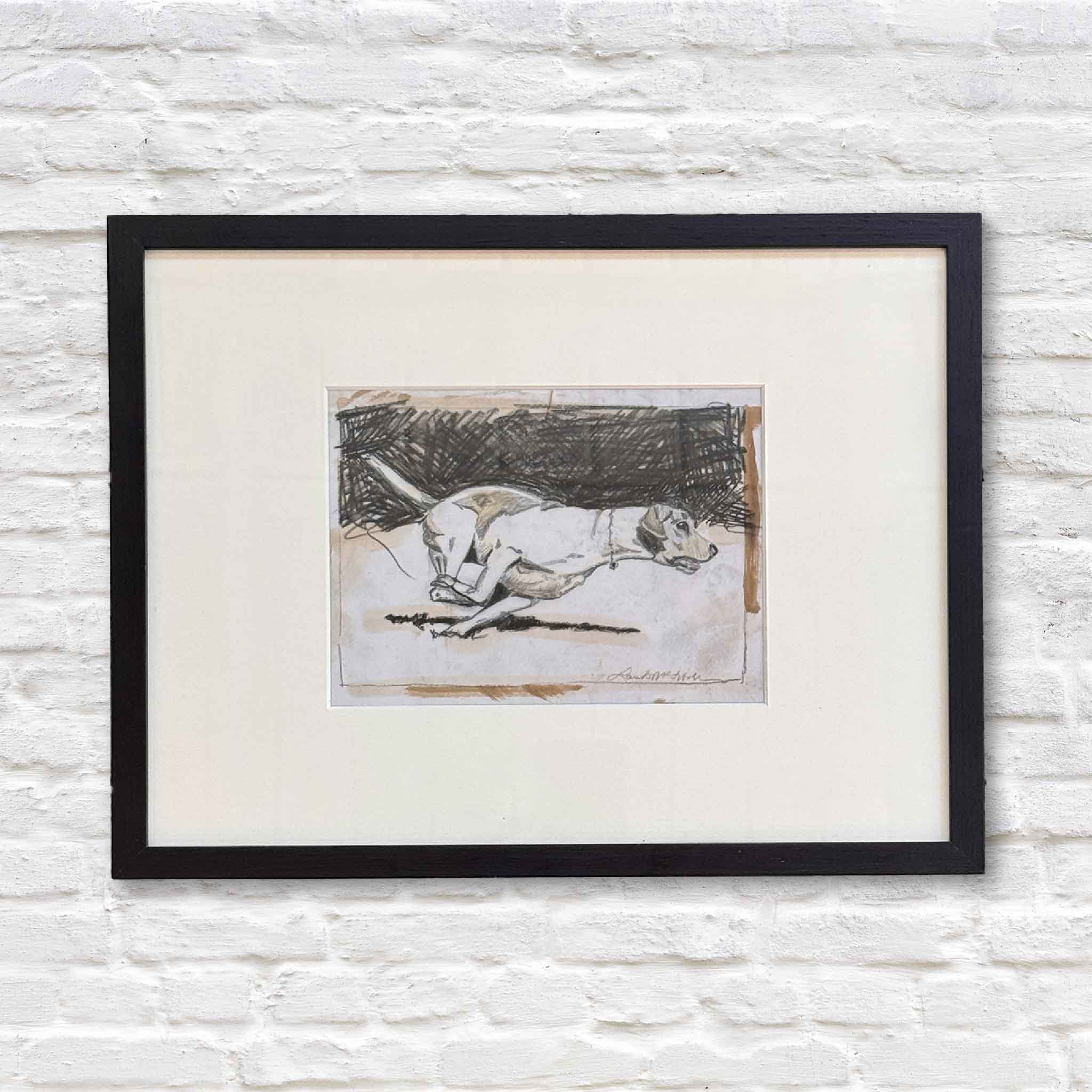 Framed original monoprint titled The Sprint by South Carolina artist Laurie McIntosh, depicting a dog racing forward with all four paws airborne, a one-of-a-kind artwork available at Gray Man Gallery in Pawleys Island, South Carolina.