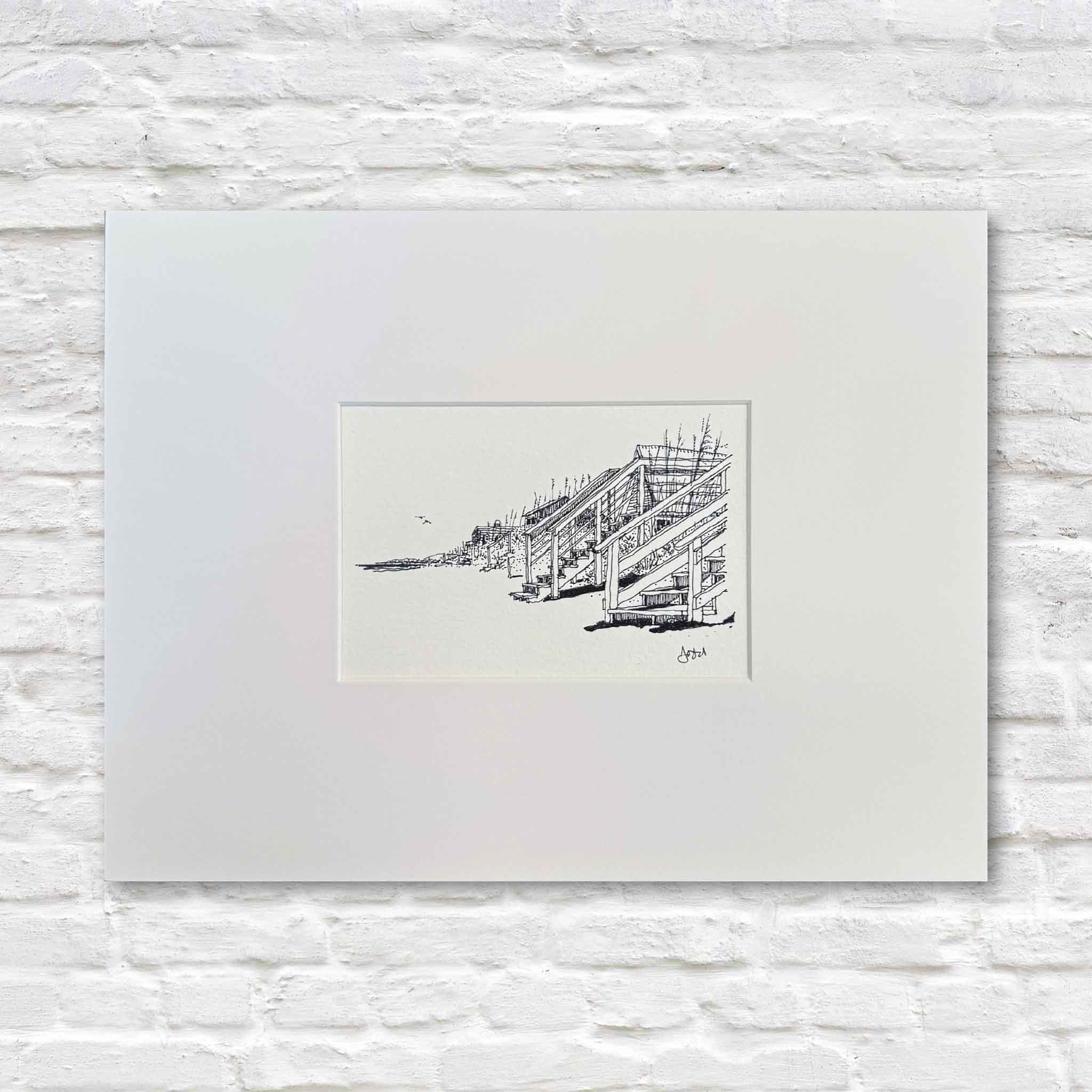 Pen-and-ink coastal print titled Beach Front Stairs by Todd Halamka, featuring weathered wooden beach stairs leading through dunes toward the shoreline, professionally matted and photographed at Gray Man Gallery in Pawleys Island, South Carolina.