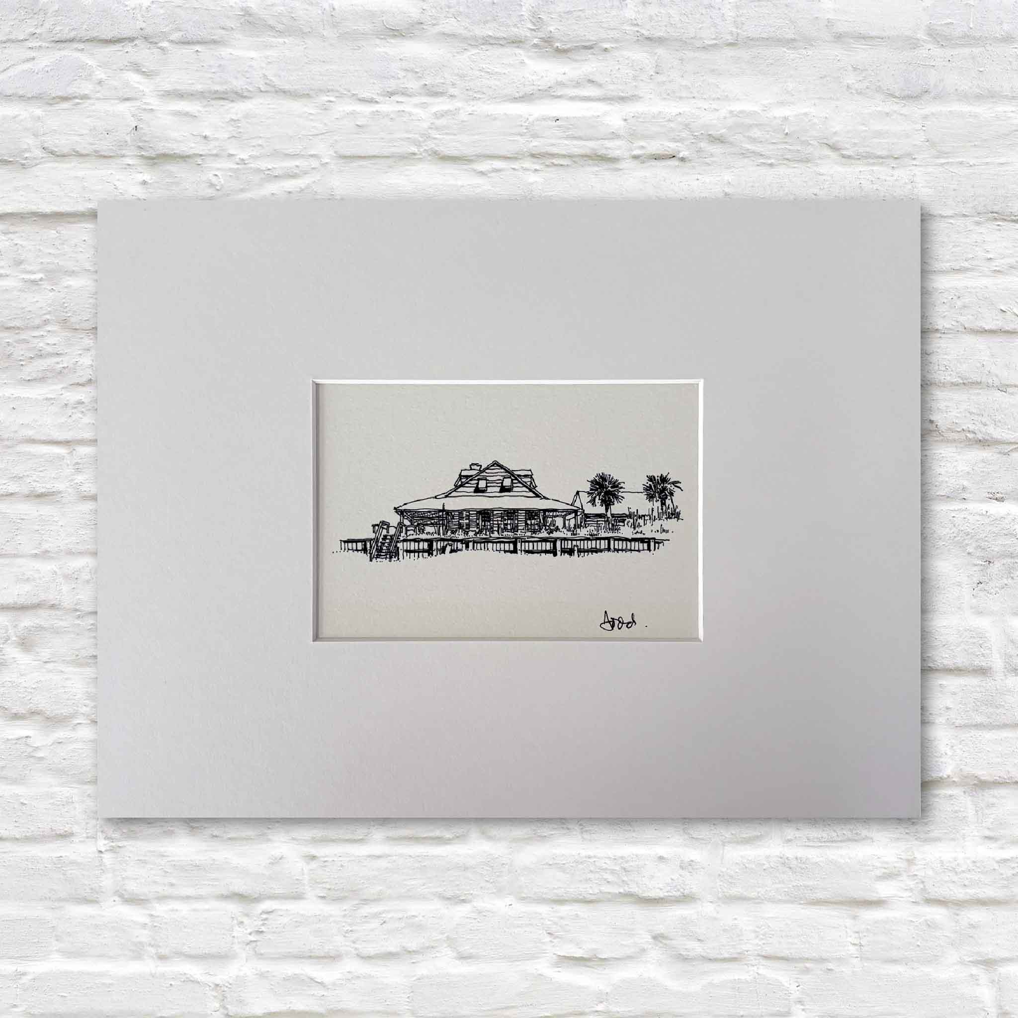 Todd Halamka's Caledonia at Pawleys Island pen-and-ink print, professionally matted to a standard 11x14 size and available at Gray Man Gallery in Pawleys Island, South Carolina. The artwork depicts the historic Caledonia Fish Club building, making it easy to frame with one of our ready-made frames without custom framing.