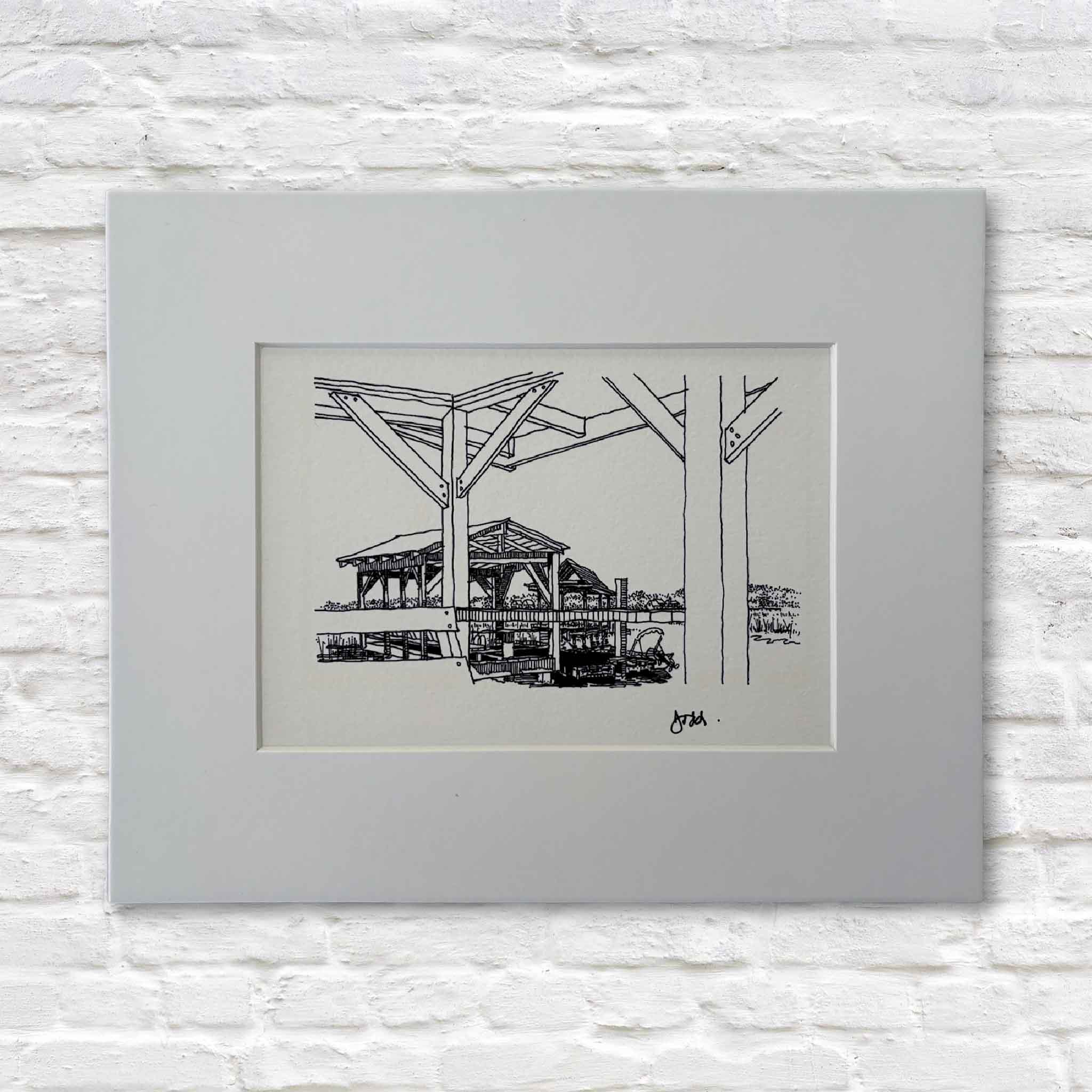 Matted black-ink line drawing of a Lowcountry marsh dock by Todd Halamka, displayed against a white brick background.