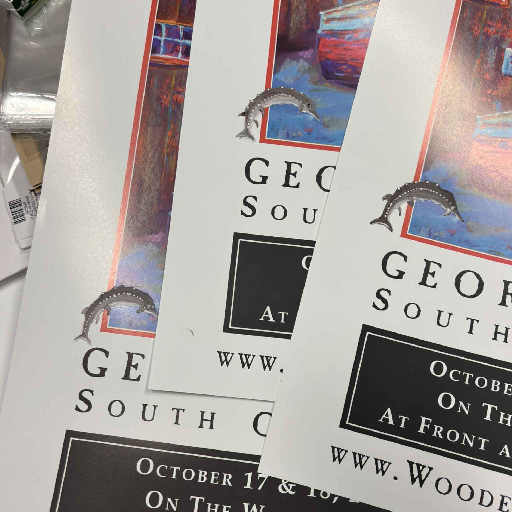 Close-up of Vida Miller’s original hand-painted sturgeon remarques on her 2026 Georgetown Wooden Boat Show posters, showing how each of the ten signed and numbered limited-edition posters is individually embellished by the artist and therefore unique, available exclusively at Gray Man Gallery in Pawleys Island, South Carolina.