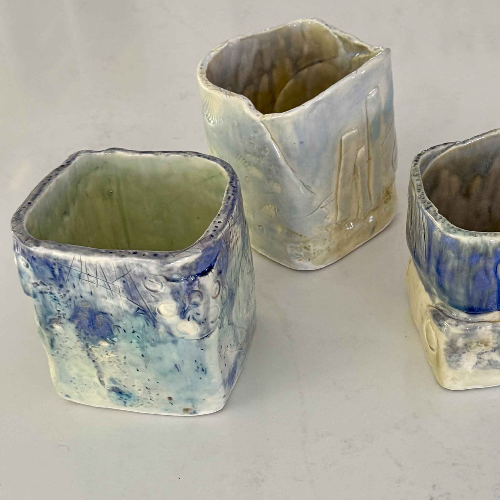 Collection of handmade Seafoam Ceramic Vases by Pawleys Island artist Vida Miller showing one-of-a-kind coastal glaze movement, carved textures, and sculptural Lowcountry pottery forms at Gray Man Gallery