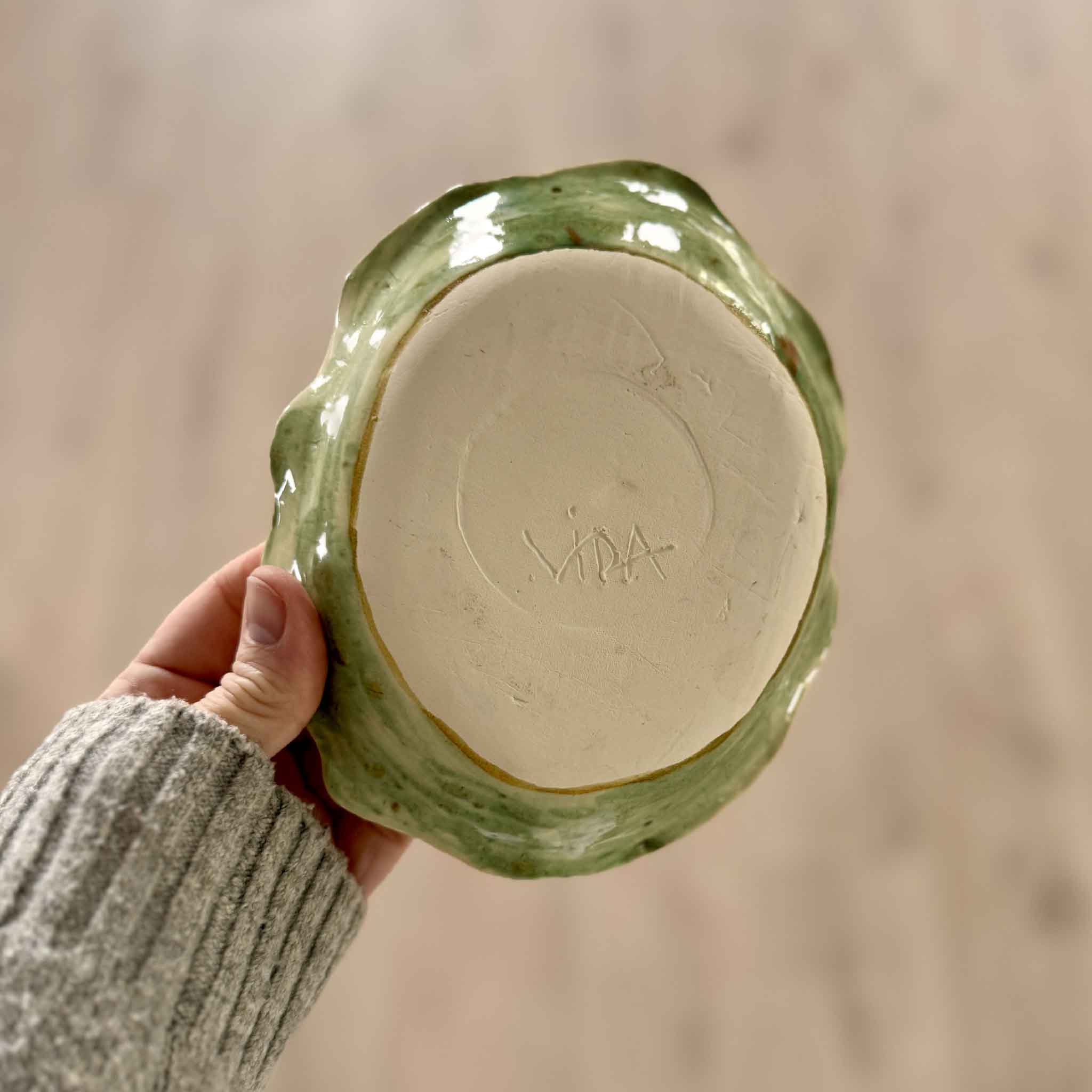 Underside of Marsh Drift Bowl handmade by Pawleys Island artist Vida Miller, showing carved VIDA signature on base with soft seafoam green glazed rim, available at Gray Man Gallery