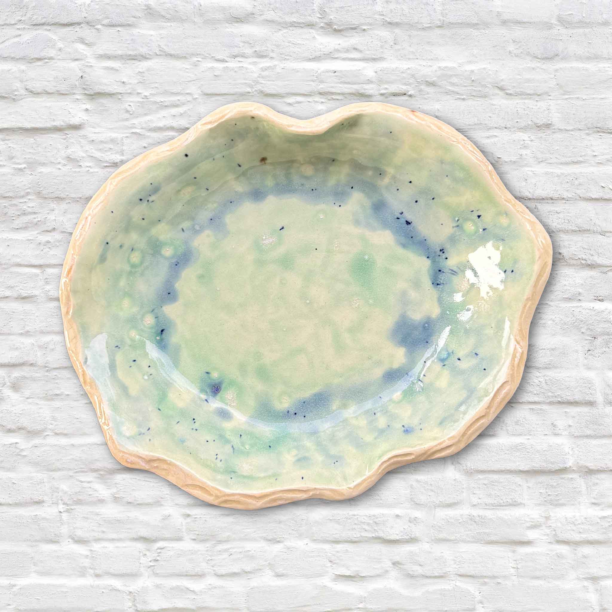Marsh Drift Bowl by Vida Miller featuring layered seafoam and blue-green glaze with softly scalloped edge, handmade Lowcountry ceramic at Gray Man Gallery in Pawleys Island