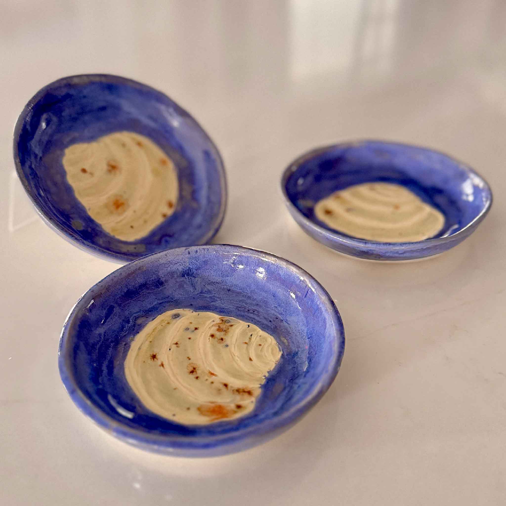 Grouping of three Pawleys Island Shell Dish – Delft Blue ceramics by local artist Vida Miller, featuring bright blue glaze and carved ivory shell centers, handcrafted coastal pottery at Gray Man Gallery in Pawleys Island