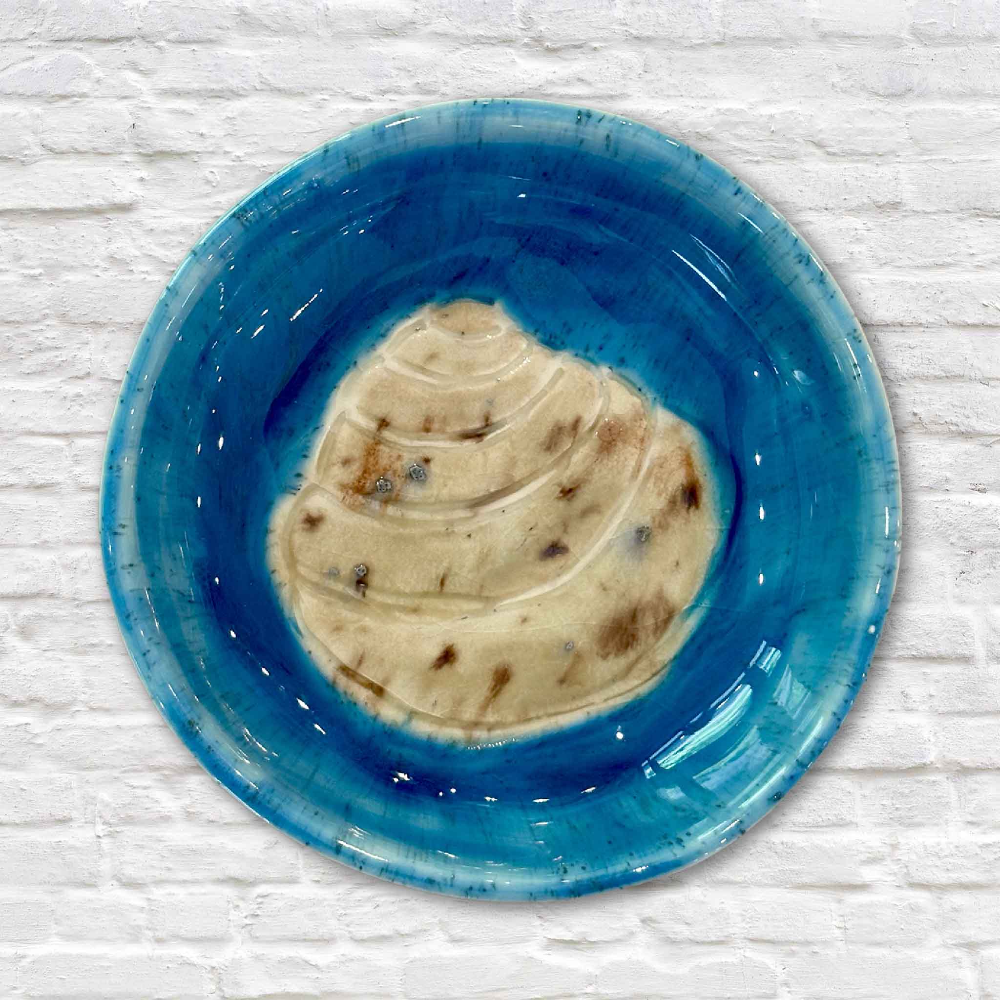 Close-up of Vida Miller's handmade Pawleys Island Shell ceramic dish finished in a rich turquoise glaze with an embossed shell centerpiece. This handcrafted coastal pottery dish from Gray Man Gallery highlights the natural beauty of South Carolina shell-inspired artwork.