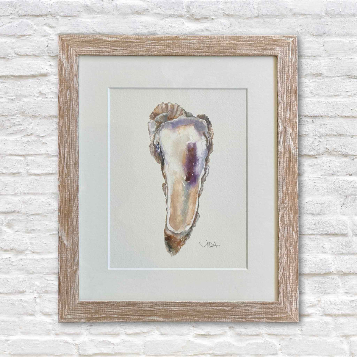 Pawleys Oyster I original watercolor painting of a Lowcountry oyster shell by Vida Miller, professionally matted and framed in light wood at Gray Man Gallery in Pawleys Island, South Carolina