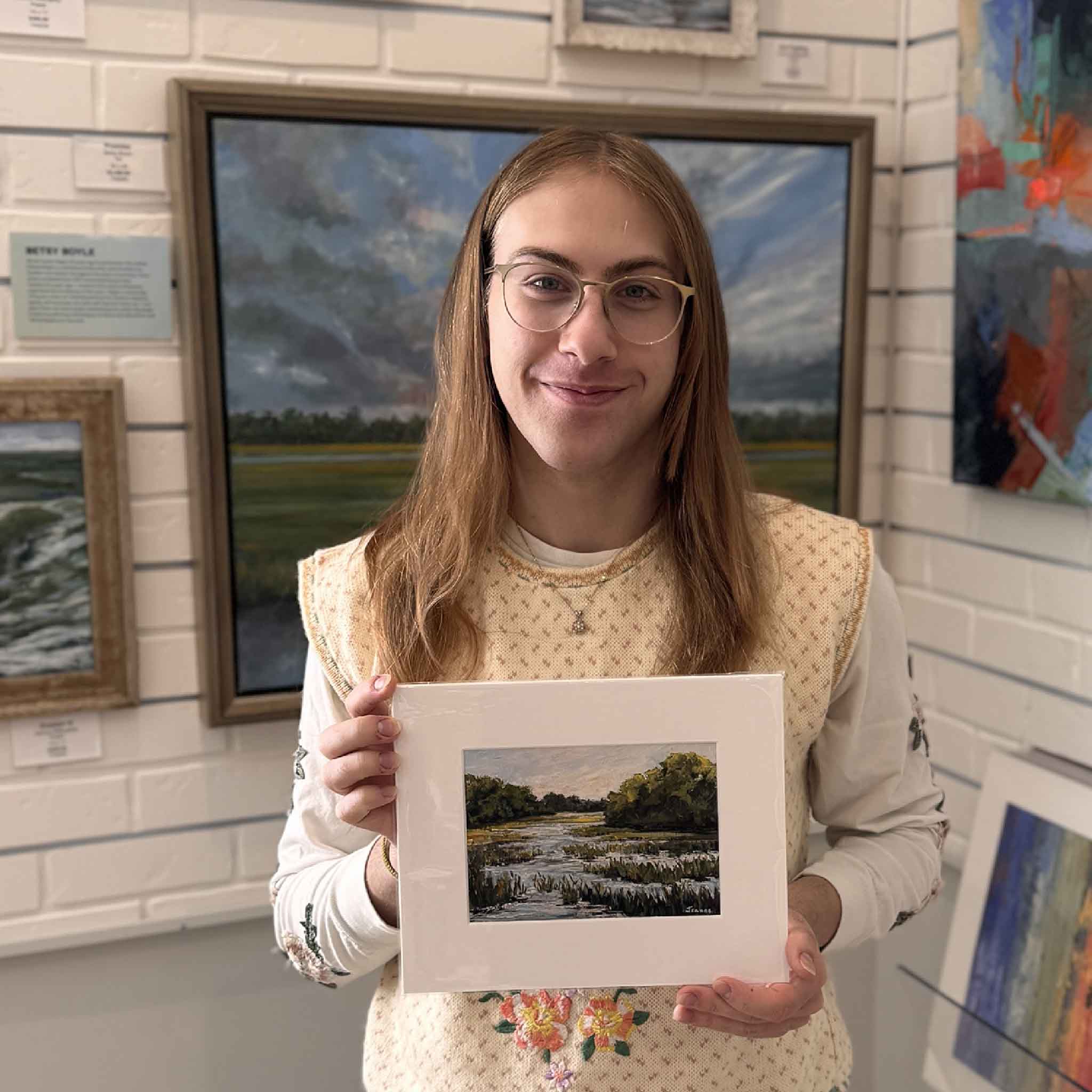 A customer holding the matted 8×10 version of Jeanne O’Neal’s marsh print, showing scale and presentation.